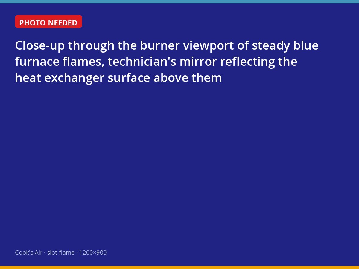 Blue burner flames seen through a furnace inspection port