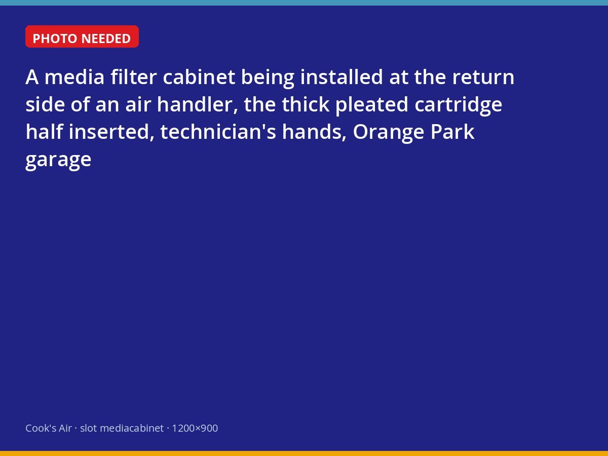 Technician sliding a media filter cartridge into a new cabinet at an air handler